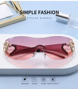 Chic Y2K rimless sunglasses with pink gradient lenses and gold heart-shaped hinges.