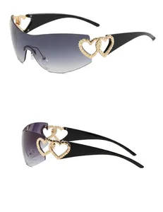 Detail view of Y2K style rimless sunglasses with gold hollow heart-shaped temple accents