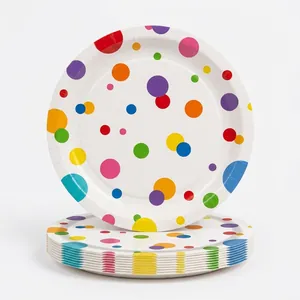 Close-up of disposable paper plates with colorful polka dot design for birthday parties