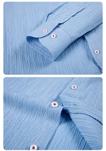 Detailed view of blue seersucker shirt showing crinkle texture and red stitched buttons