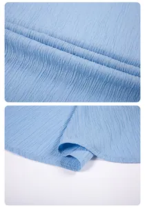 Detailed macro view of light blue crinkled textured fabric on men's summer shirt
