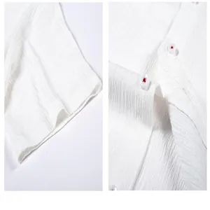 Macro-opname van wit herenoverhemd met zeegolf-textuur en details van de knopen.