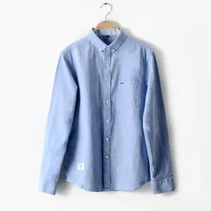 Classic light blue professional non-iron long sleeve business shirt on a wooden hanger