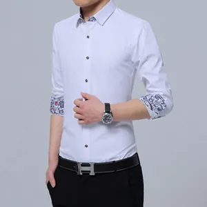 Detail of white business dress shirt featuring contrast patterned floral cuffs and collar.