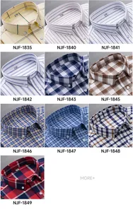 Close-up view of various men's cotton Oxford shirts in different plaid and striped patterns.