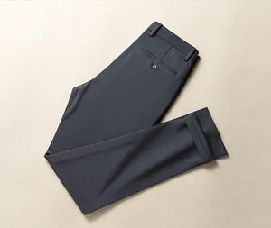 High-quality close-up view of folded dark grey formal business dress pants for men.