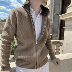 Detail of men's ribbed knit cardigan featuring a plush fur collar and dual zipper.