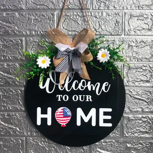 Detail of Independence Day wooden door sign with burlap bow and USA flag balloon