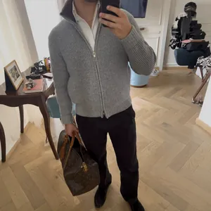 Men's grey ribbed knit zip-up cardigan sweater with a stylish lapel collar design
