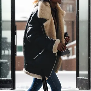 Detail of a black faux shearling aviator jacket for women in a snowy winter street scene