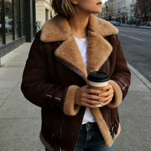 Street style shot of a brown suede shearling jacket with warm wool lapels and buckles.
