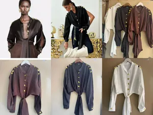Detailed view of women's tie-front shirt with unique Schiaparelli-style gold buttons.