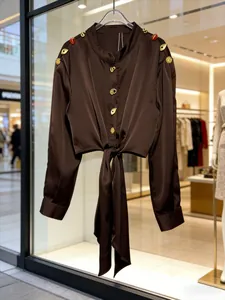 Chic chocolate brown long-sleeved blouse with gold buttons and a front tie waist