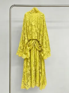 Detail view of a French style yellow lace dress with bell sleeves on a hanger.