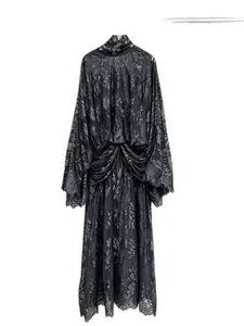 Elegant black French lace dress with high neck and flared trumpet sleeves.