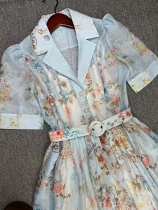 Close-up of an elegant French style floral print dress with matching belt and lapel collar