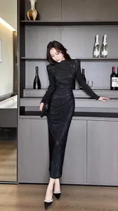 Full length view of an elegant black pleated bodycon long dress with dark patterns