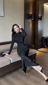 Elegant black crinkle pleat long sleeve bodycon dress with shimmering fabric.