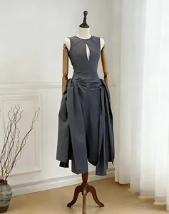 Full view of pleated sleeveless maxi dress on mannequin in minimalist studio setting