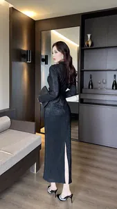 Back view of elegant black pleated bodycon maxi dress with split hem design