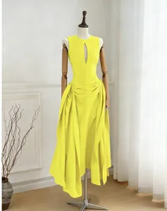 Elegant yellow sleeveless maxi dress with front cutout and pleated irregular skirt detail