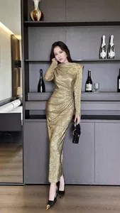 Elegant gold pleated maxi evening dress featuring a slim-fit silhouette and long sleeves