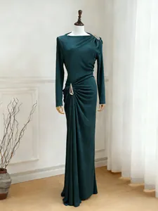 Front view of deep teal long-sleeved ruched slim-fit dress on boutique mannequin