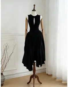 Elegant black sleeveless dress with chest cutout and pleated irregular hem on mannequin