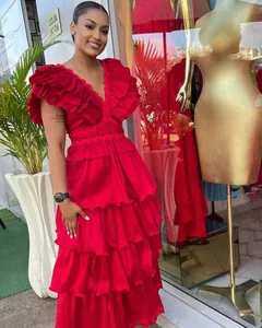 Elegant red pleated evening gown showing multi-layered ruffles and deep V-neckline
