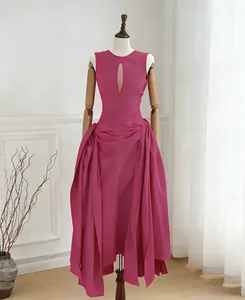Detail view of an elegant magenta sleeveless dress with front cutout and side pleats.