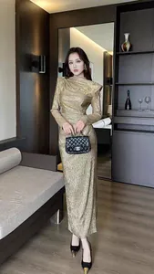 Elegant gold metallic long-sleeve bodycon maxi dress featuring vintage shoulder detail