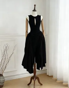 Elegant black sleeveless dress with chest cutout and asymmetrical pleated skirt detail