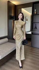 Elegant gold pleated long sleeve maxi dress with padded shoulders in French vintage style