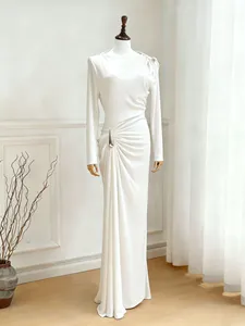 Elegant white long sleeve ruched maxi dress with metallic waist detail