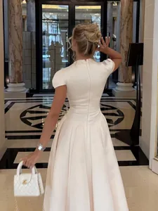 Elegant back view of a high-end cream acetate puff dress designed for formal occasions