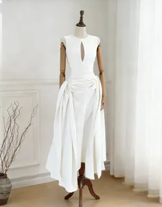 Elegant white sleeveless pleated midi dress featuring a stylish teardrop hollow-out design