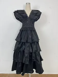 Detail view of black pleated multi-layered ruffle evening gown with a deep V-neckline
