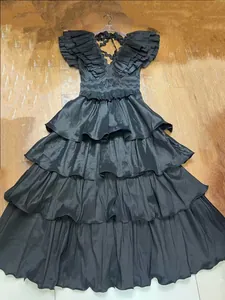 Elegant black pleated tiered evening gown with ruffled sleeve details for banquet
