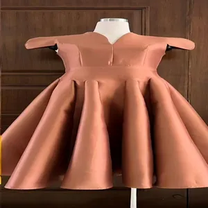 Elegant copper V-neck puffy acetate cocktail dress with pleated petal skirt.
