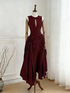 Elegant wine red sleeveless dress with keyhole cutout and asymmetrical ruched skirt