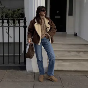 Stylish brown shearling jacket with lamb wool lining in a retro street style look