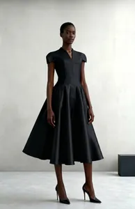 Detail view of the elegant black V-neck flared dress with petal-style shoulders.