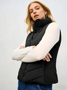 Close-up detail of women's black stand-collar padded vest with quilted puffer texture