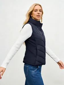 Side view of a stylish women's navy blue quilted puffer vest with a high stand collar