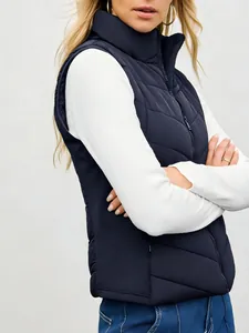 Side view detail of women's navy blue quilted puffer vest featuring a stand collar design