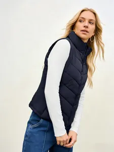 Professional side view of women's navy blue quilted stand collar puffer vest jacket