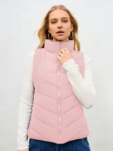 Detailed view of a stylish pink stand collar puffer vest for women worn by a model.