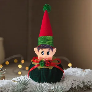 Detailed view of a festive Christmas elf figurine with a red hat on a snowy surface
