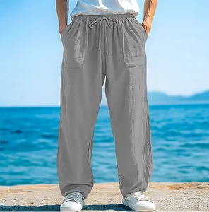 Detail shot of grey men's loose beach pants with drawstring waist and pockets.
