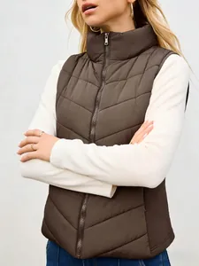 Close-up detail of a brown quilted puffer vest with stand collar and zipper front